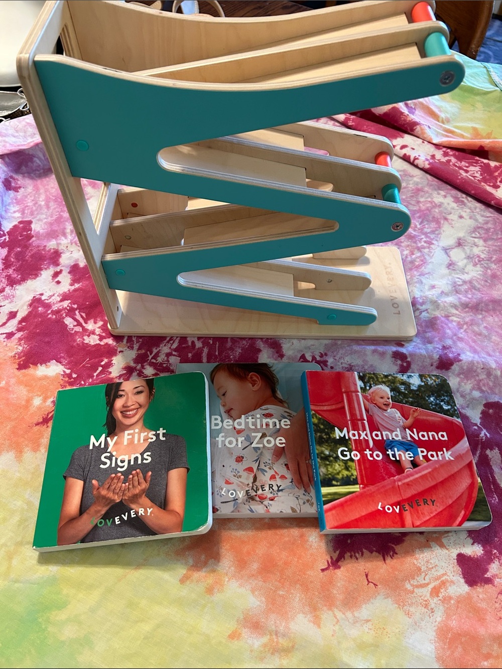 3 Lovevery books & race track